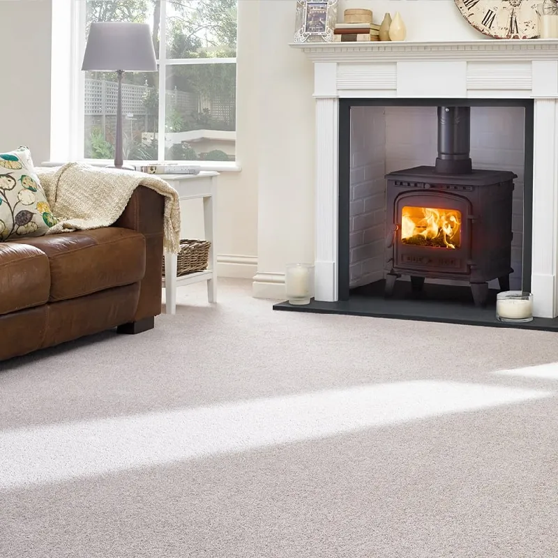 light grey fireproof carpeting installed around a traditional black wood-burning stove
