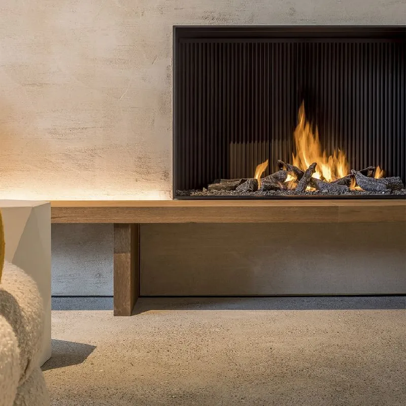 modern fireplace with a black slatted interior and burning logs