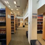 Beige textured fireproof carpet in a multi-level library setting.