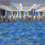 Blue patterned fireproof carpet in a luxury banquet hall.