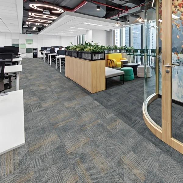 Geometric gray carpet tiles in a bright office