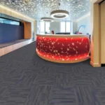 Dark grey linear fireproof carpet tiles in a modern reception area.
