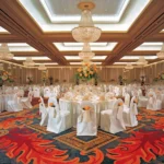Elegant patterned fireproof carpet in a grand hotel ballroom.