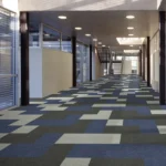 Geometric blue and grey fireproof carpet tiles in a commercial space.