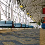 Geometric patterned fireproof carpet in a modern airport lounge.
