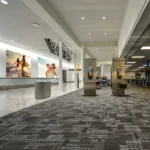 Grey patterned fireproof carpet in a modern airport terminal.