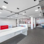 Grey speckled fireproof carpet in a modern retail showroom.