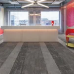 Grey striped fireproof carpet in a modern industrial office lobby.