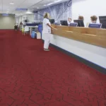 Red patterned fireproof carpet in a medical facility reception area.